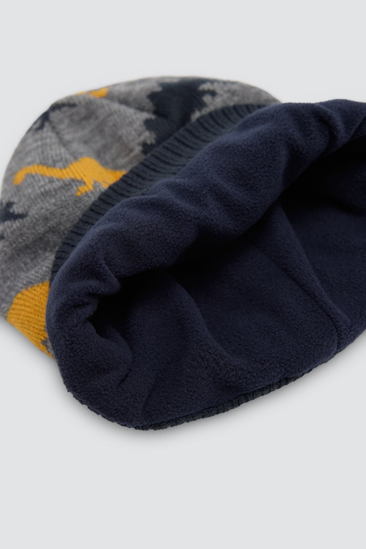 Bonnet garçon en maille imprimé dinosaures avec doublure polaire