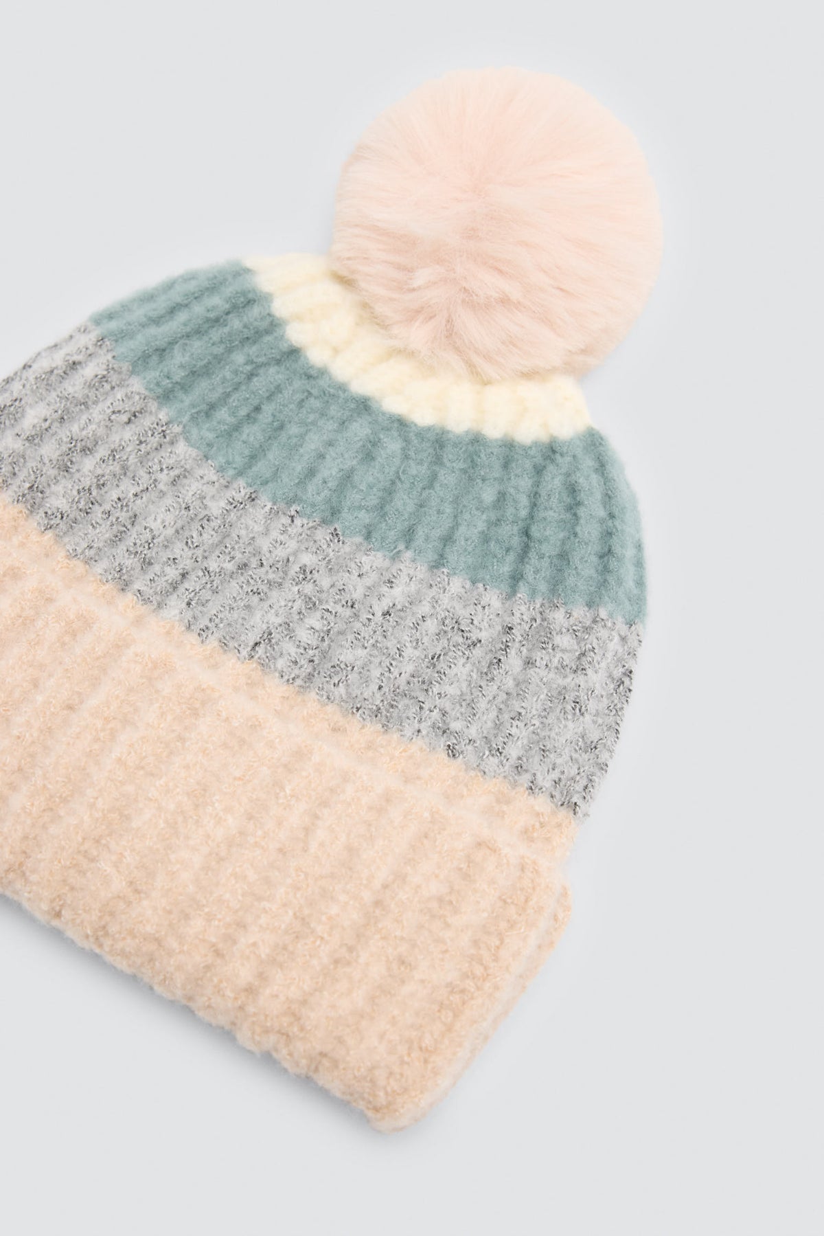 Bonnet en maille multicolore à pompon avec doublure polaire